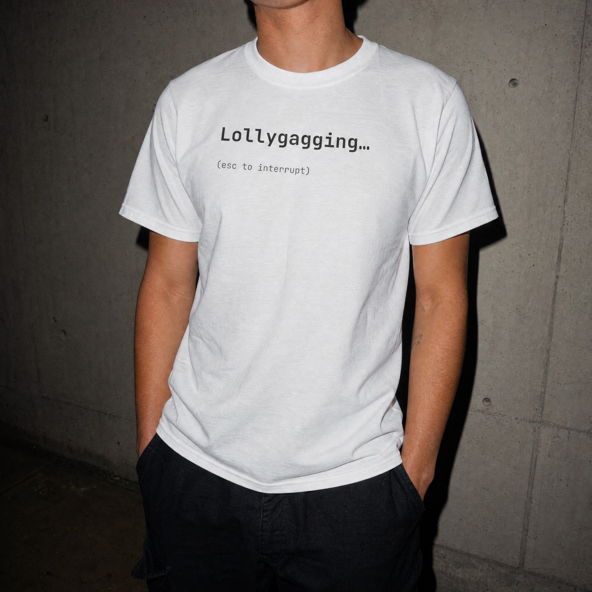 White Lollygagging esc to interrupt t-shirt worn at night with flash